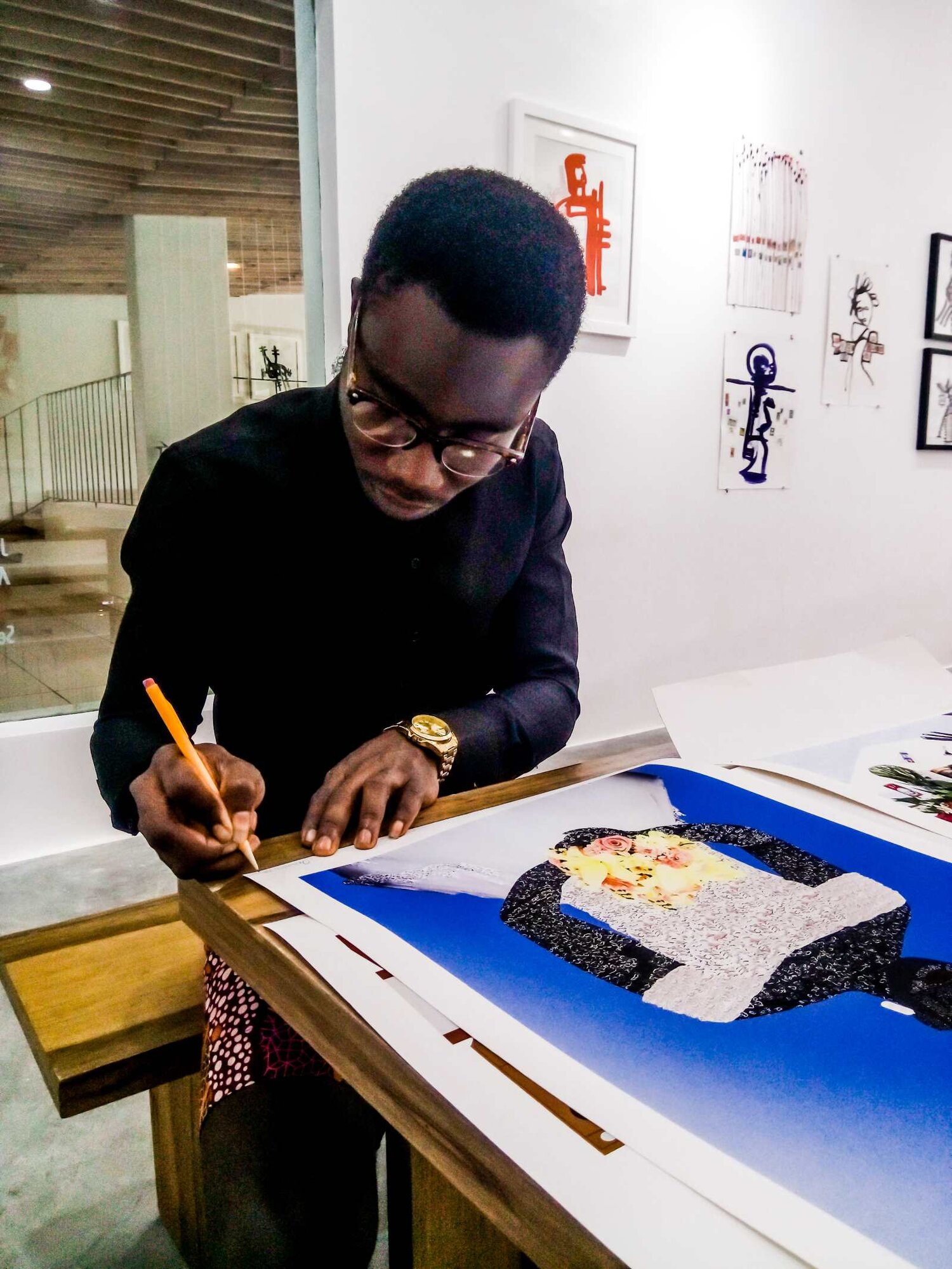 Osinachi signing a print of Nduka's Wedding Day , 2019