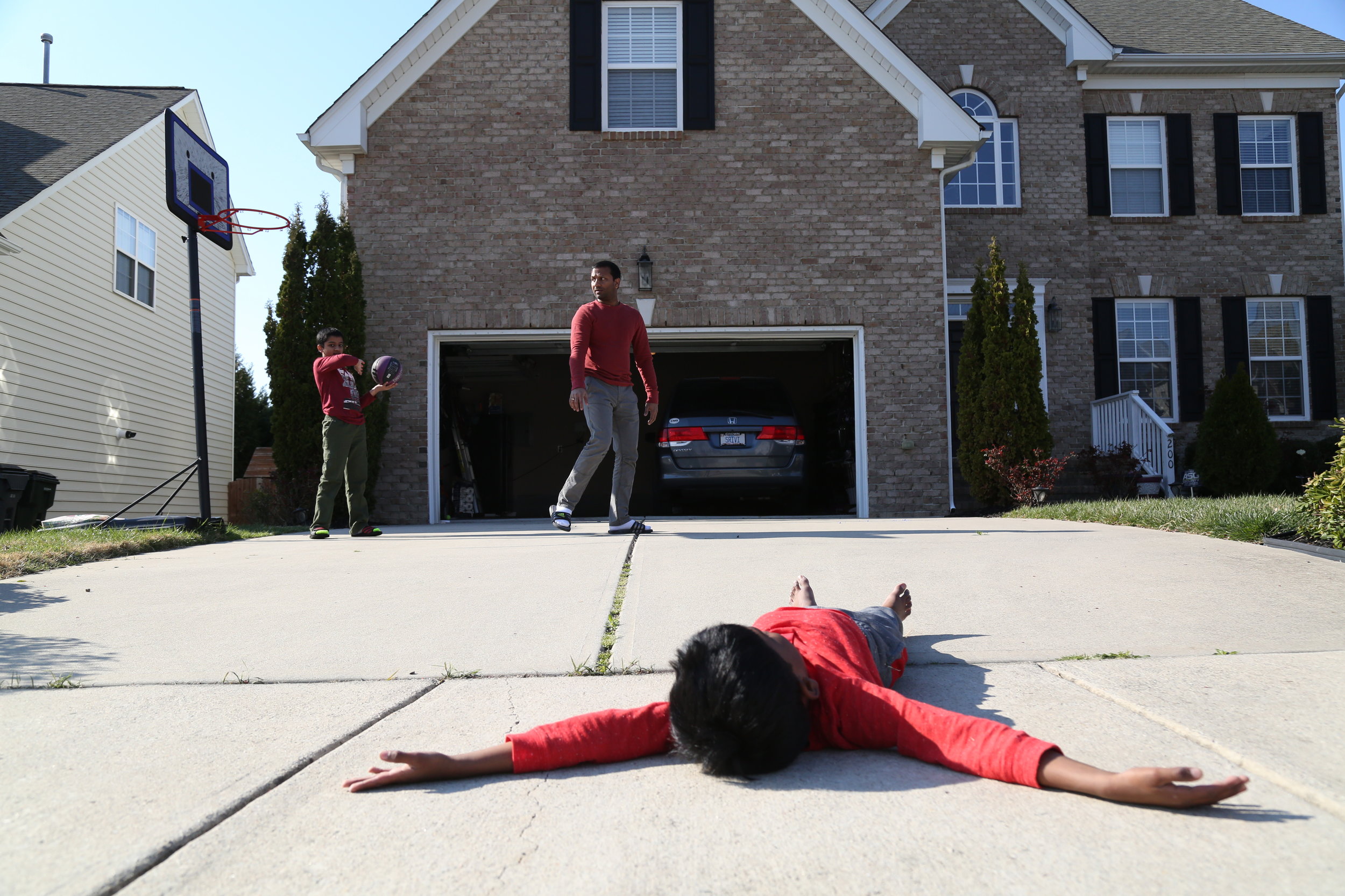  Rajesh Reddy, a native of Morrisville, plays with his two sons, Suresh Reddy (older) and Sirish Reddy (younger) in front of the garage on March.4,2017. The photo was shot as the zipcode assignment for MEJO480, photo stories class. 