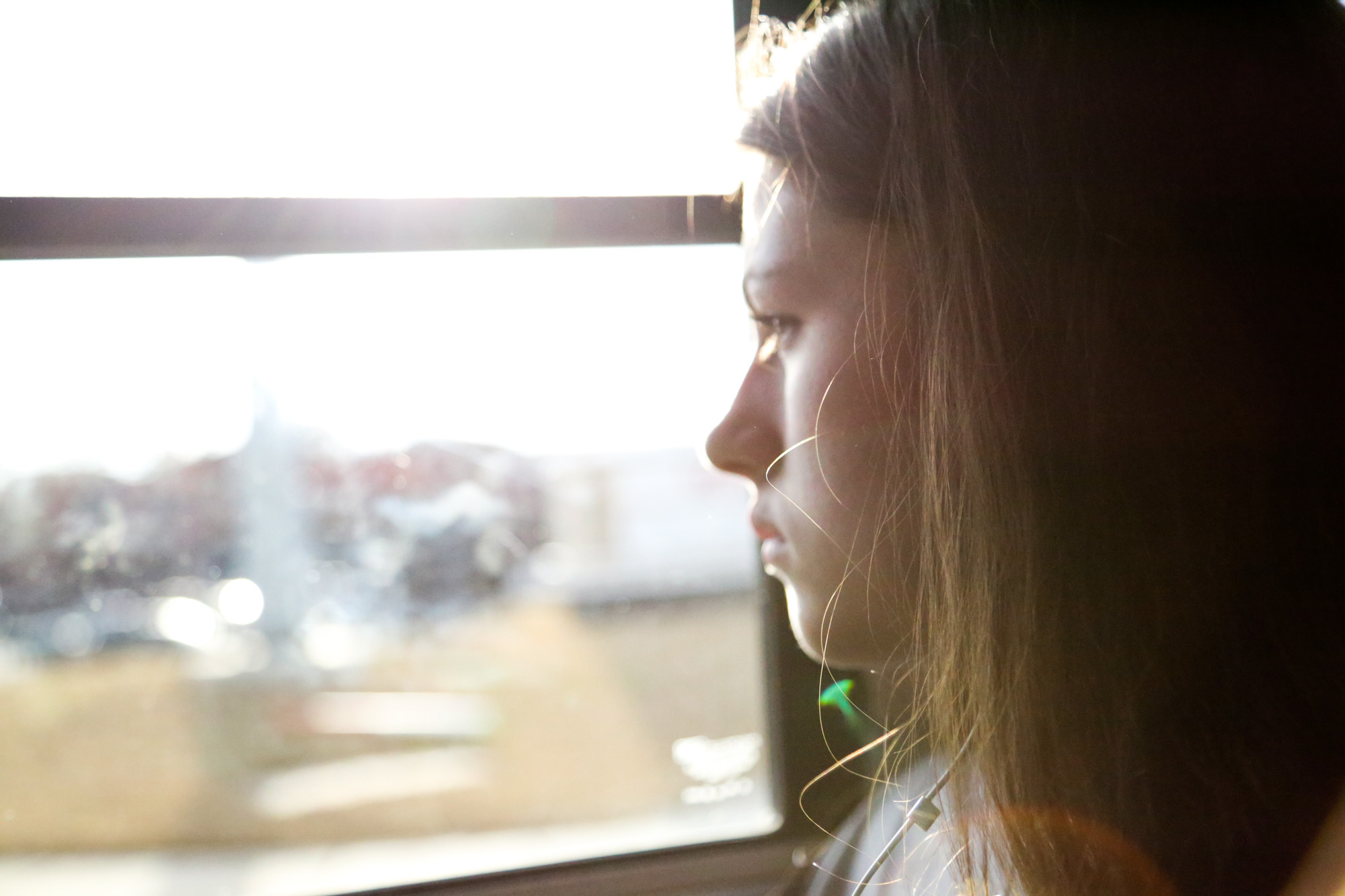  Emily Wynne looks outside through the school bus window after having snacks on their way to Athens Drive High School on Feb.10, 2017. 