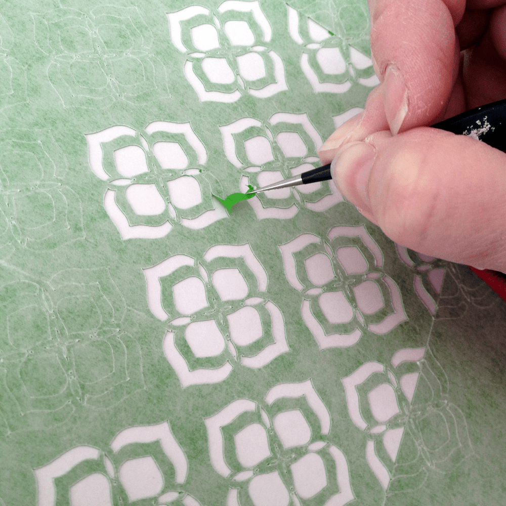 Using a hook to weed a stencil | Photo by realitydaydream.com