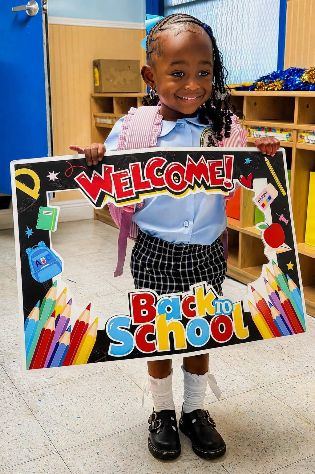 Keiance Williams' daughter, Dalonni, smiling for her back-to-school photo in her classroom at Wilcox Academy.