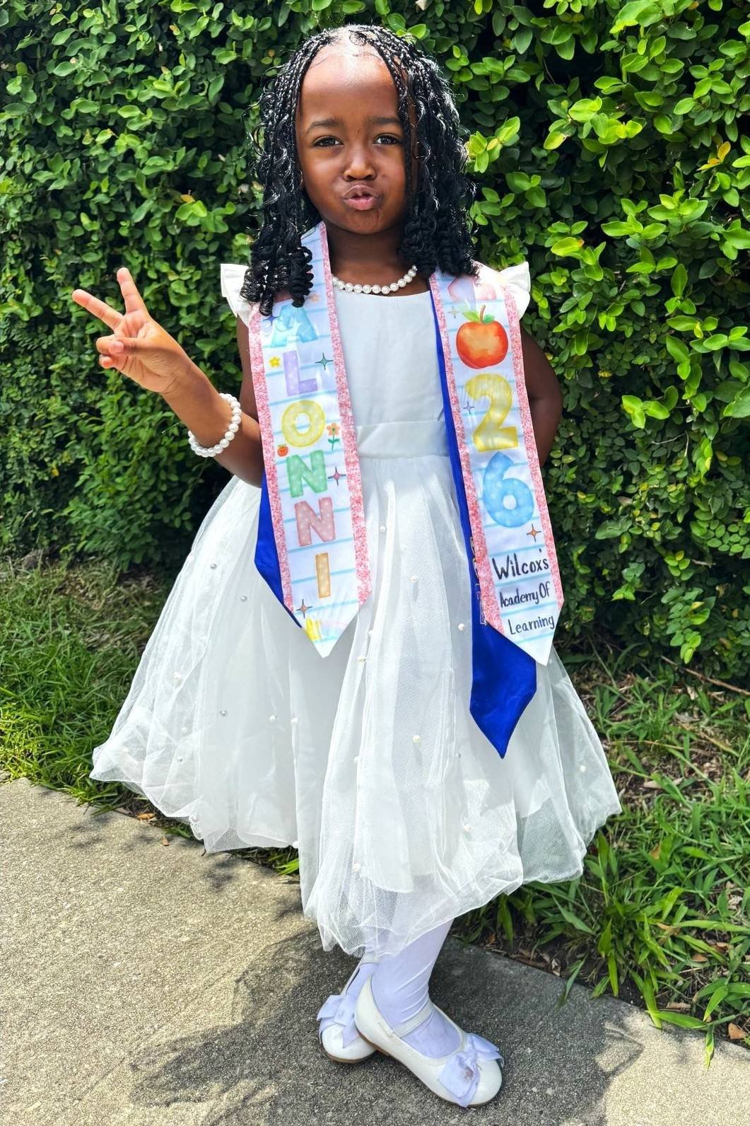 Keiance Williams' daughter, Dalonni, posing in her graduation gown and stole.