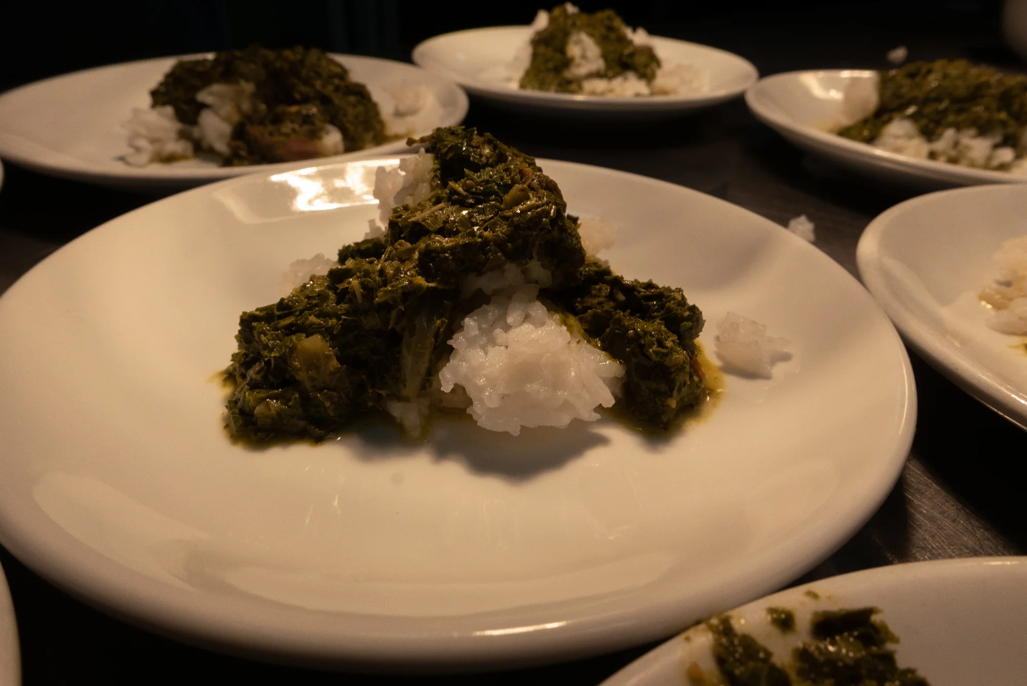 Cassava leaf over overcooked rice, Wayétu Moore, February 2019