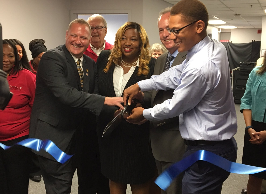Clients and staff of the KCAC join Mayor Fischer to cut the ribbon of the new KCAC location.