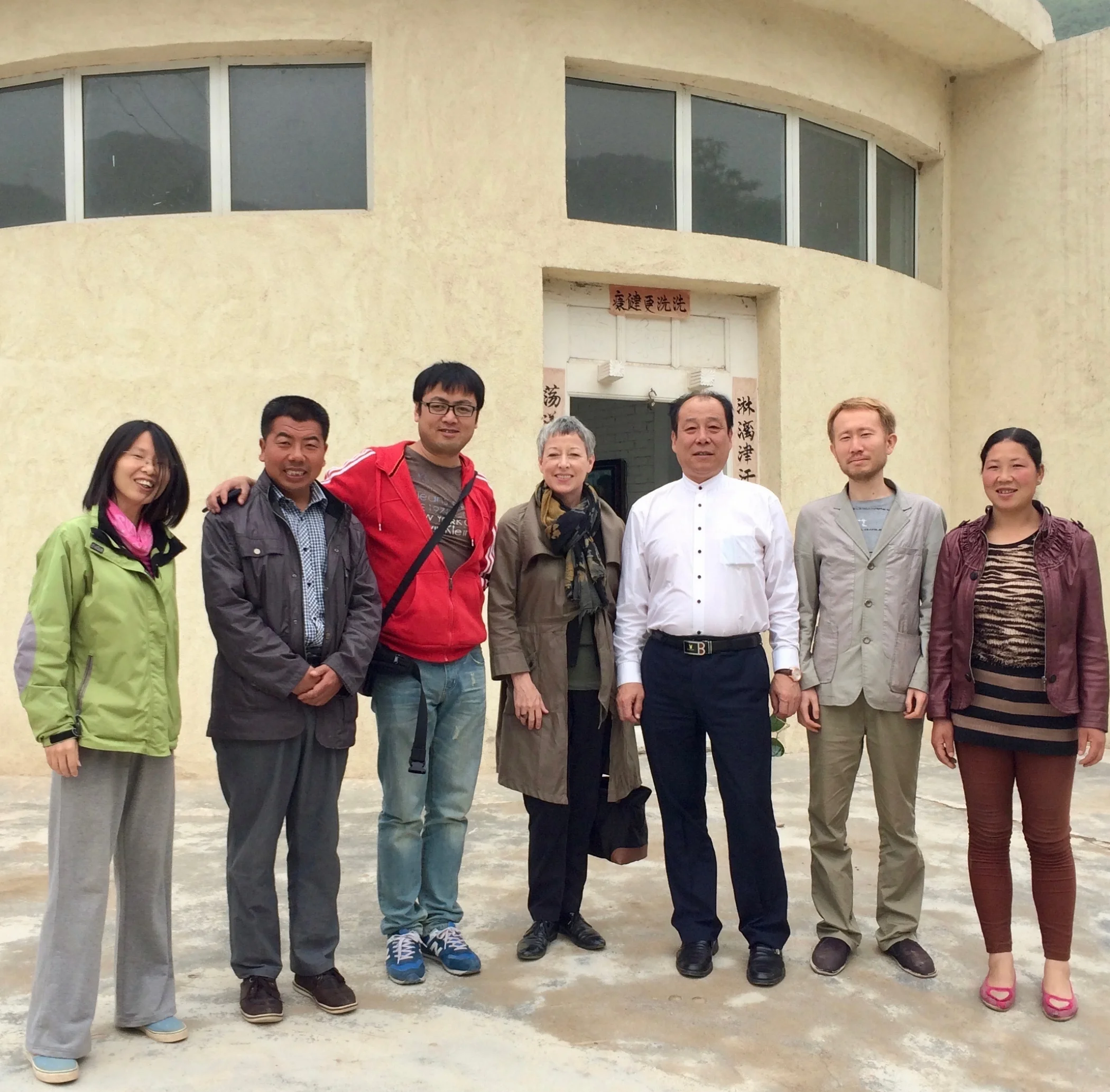 Josephine Price (pictured in middle) in front of a communal VPP bathhouse in Shaanxi Province