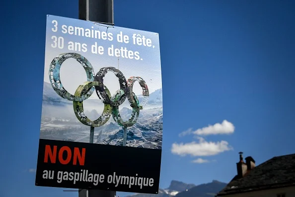 A "No on Sion 2026" campaign poster. It reads, "Three weeks of partying, 30 years of debt - No to Olympic waste" // Getty Images 
