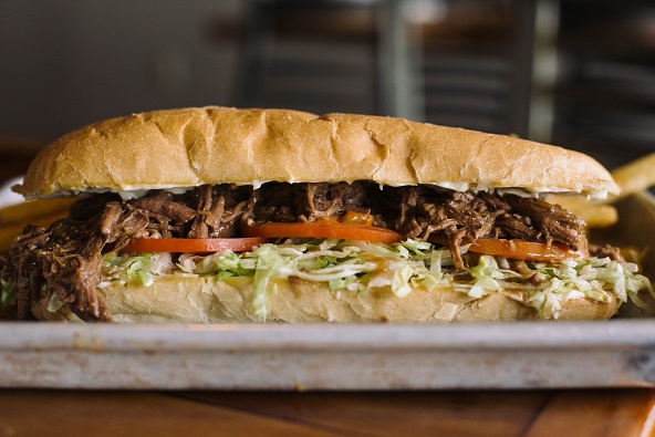 Roast Beef PoBoy Cooked in house daily. Tender cuts of inside round, oven braised in creole brown gravy for a minimum of four hours until it falls apart. Dressed with mayo, lettuce, and tomato on authentic New Orleans poboy bread. Don’t be afraid to ask for extra gravy!