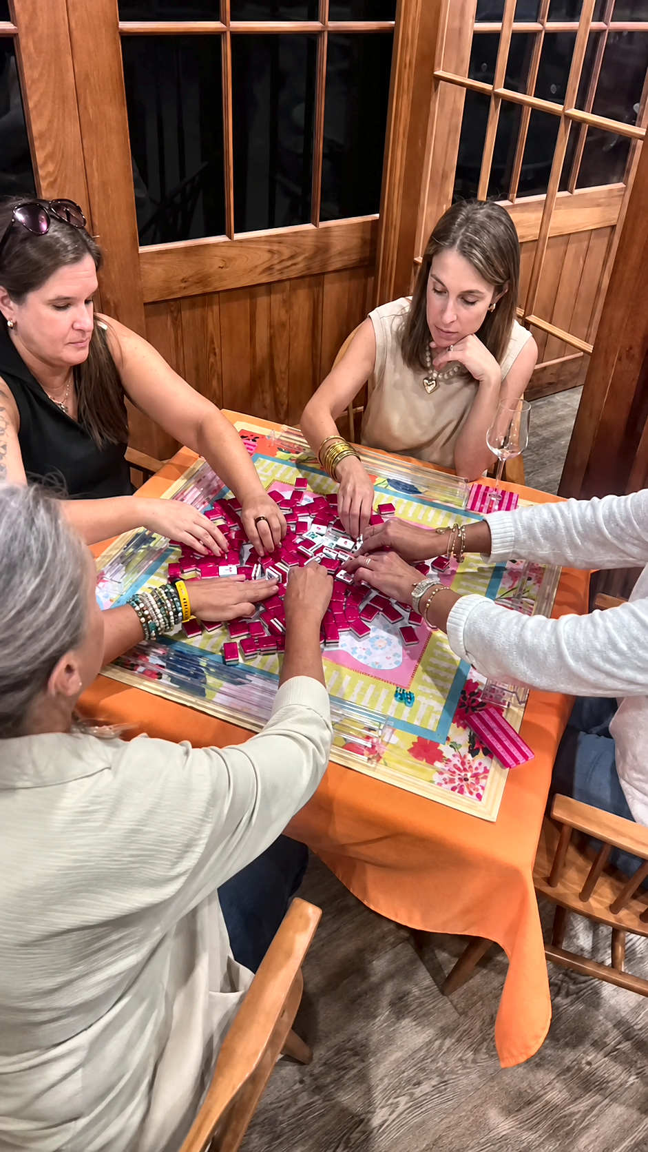 Four students practice American mahjong together during one of Marcy Maurer’s Mahj 102 lessons.