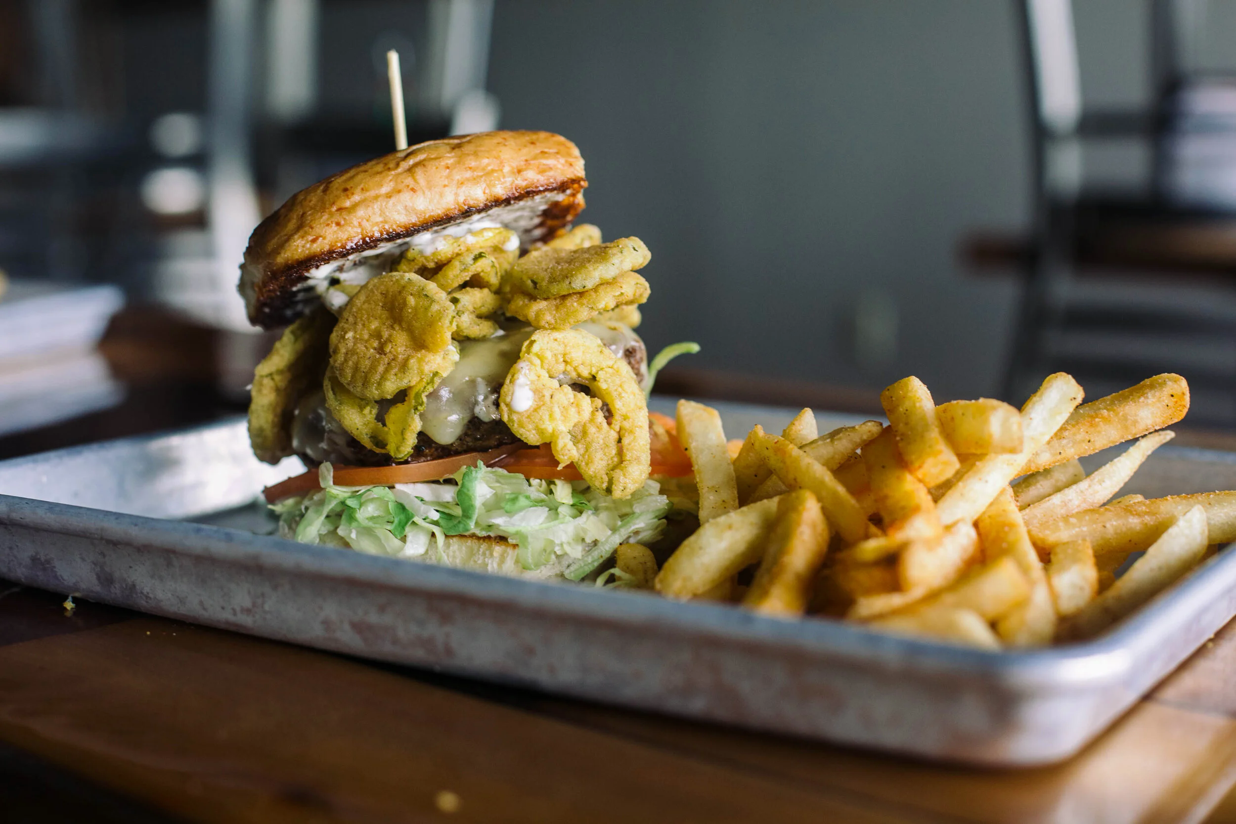 Our Mom's Fried Pickle Burger served with seasoned fries
