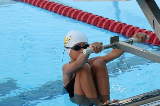 b90d4e76-614e-48a2-827c-fe393232758f-young_swimmer_first_meet_ready_to_swim_backstroke.jpg