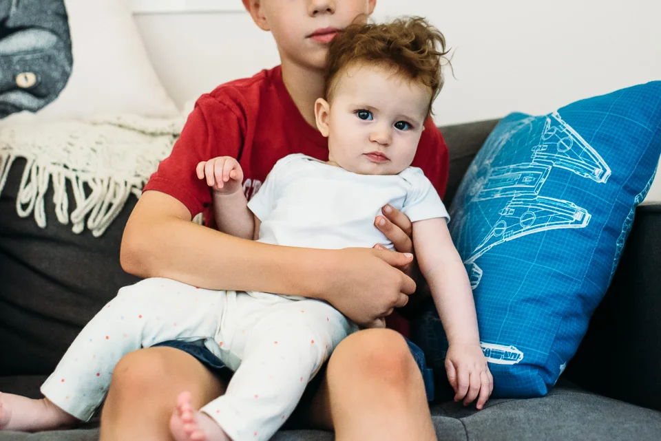 Boy holding baby girl cousin