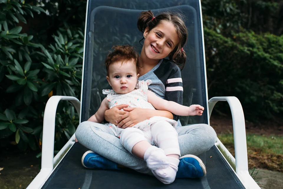 Girl holding baby cousin