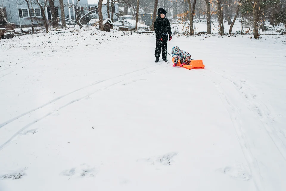 Kids playing in snow on a snow day in Westport, Connecticut.
