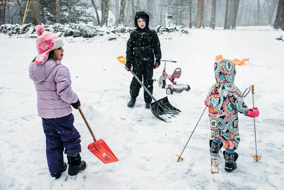 Kids playing in snow on a snow day in Westport, Connecticut.