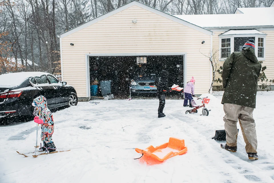 Family playing in snow on a snow day in Westport, Connecticut.