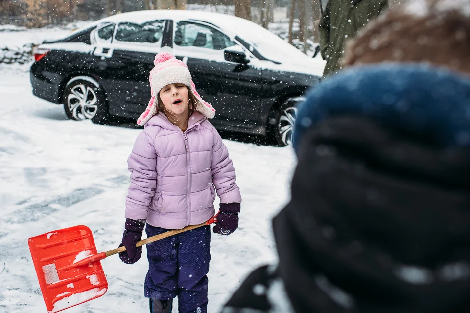 Kids playing in snow on a snow day in Westport, Connecticut.