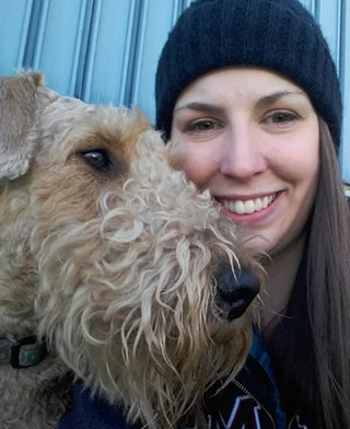 Jollytails dog Hugo giving Kyla a good snuggle
