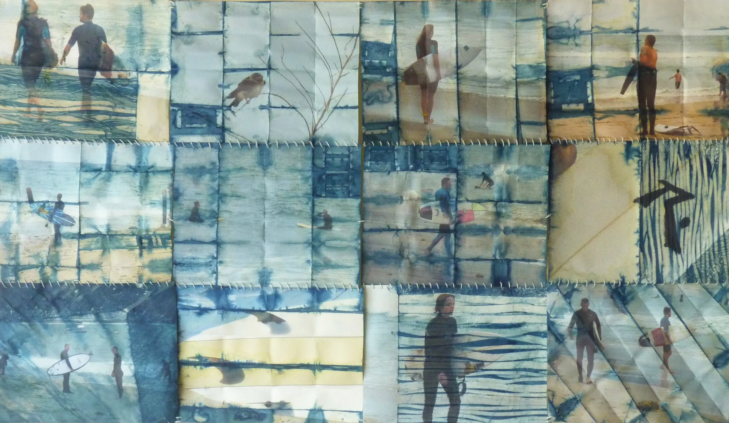 Collage of beach scenes with people, some carrying surfboards, walking or standing on the shore, and a bird perched on a branch painted on fabric panels.