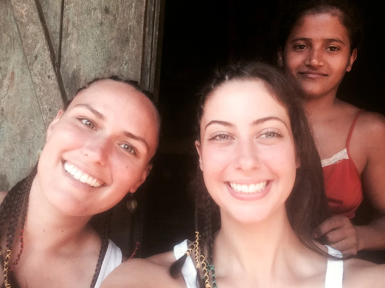 Getting our hair braided by Emily before heading into town.