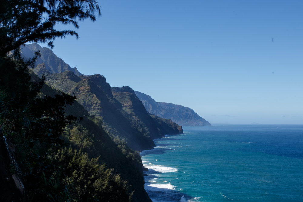  Peering out at the switchbacks and cliffs to come against a clear Hawaiian sky and calm ocean waters. 