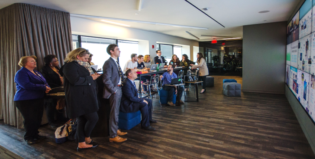 Boston City officials look on as the social team monitors the One Boston Day campaign.