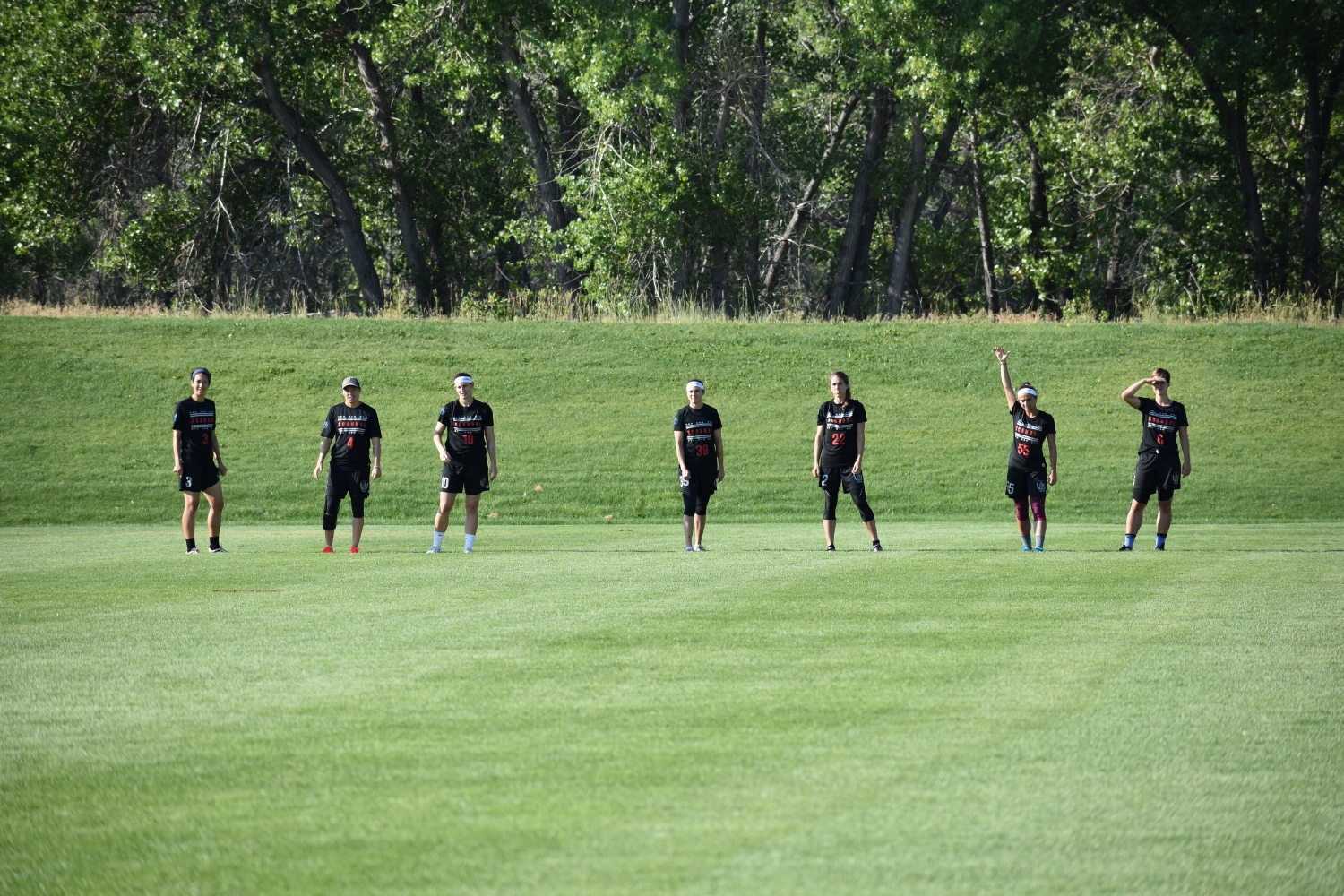 Washington DC Scandal 's captain, Molly Roy, raises her hand to signal the O-Line ready for the pull from Denver Molly Brown in a quarterfinals game on Sunday at the Colorado Cup. 