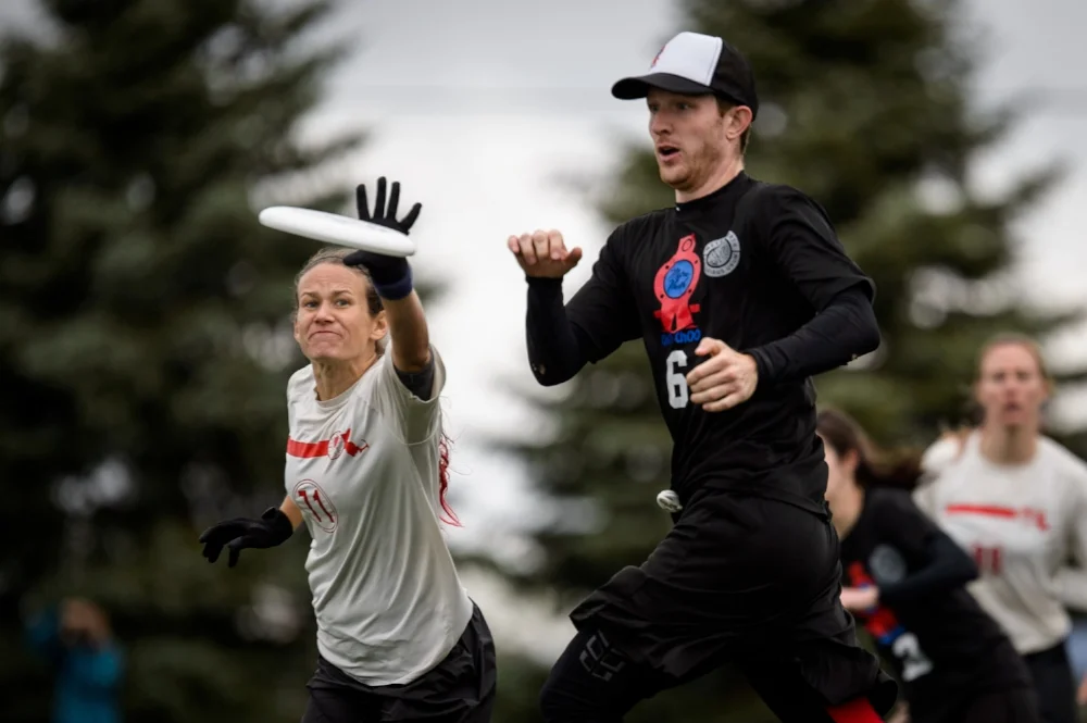 Julie Sussman of Boston Slow White gets a poach D on Connecticut Metro North 's Chris Mazur at 2016 USAU Club Nationals. (Paul Andris, UltiPhotos )