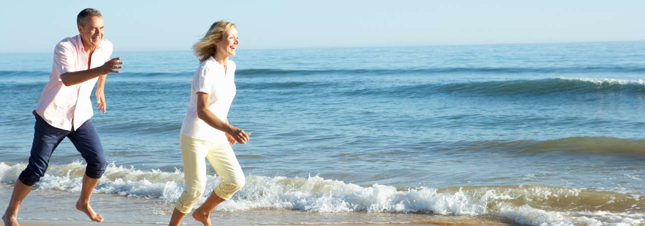 senior-couple-enjoying-romantic-beach-holiday.jpg