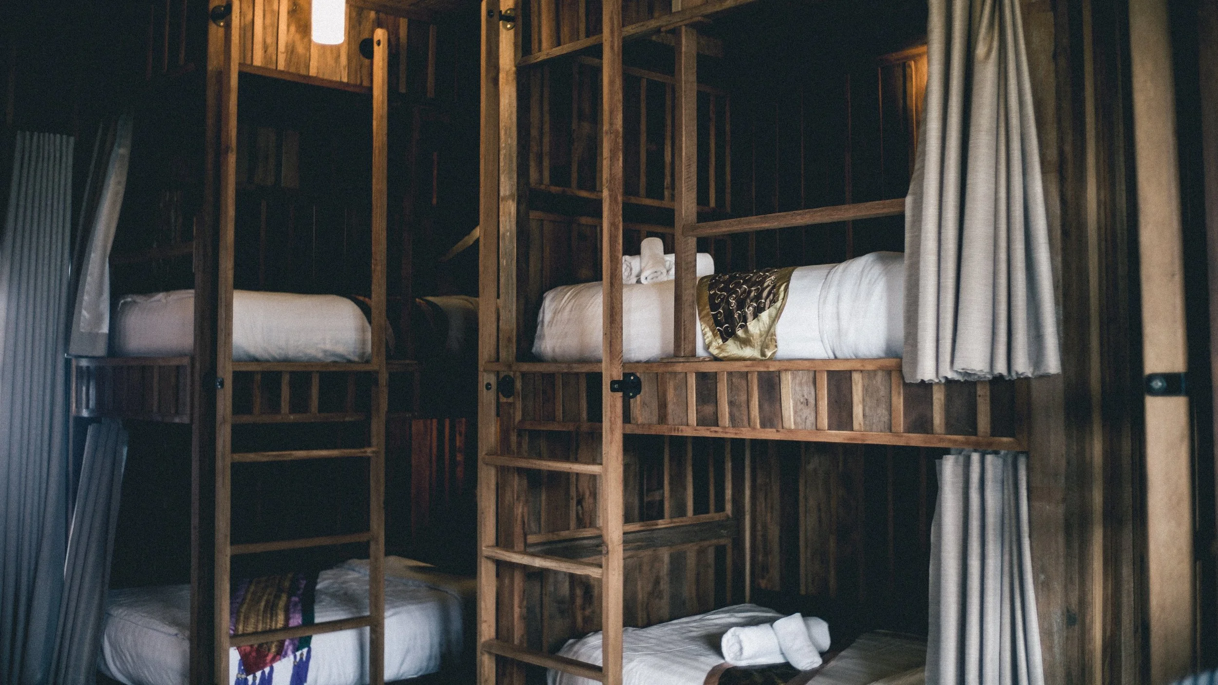wooden bunk beds in hostel dorm room