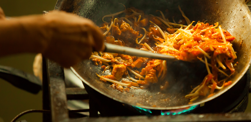 pad+thai+in+wok+being+stirred+looking+tasty.jpeg