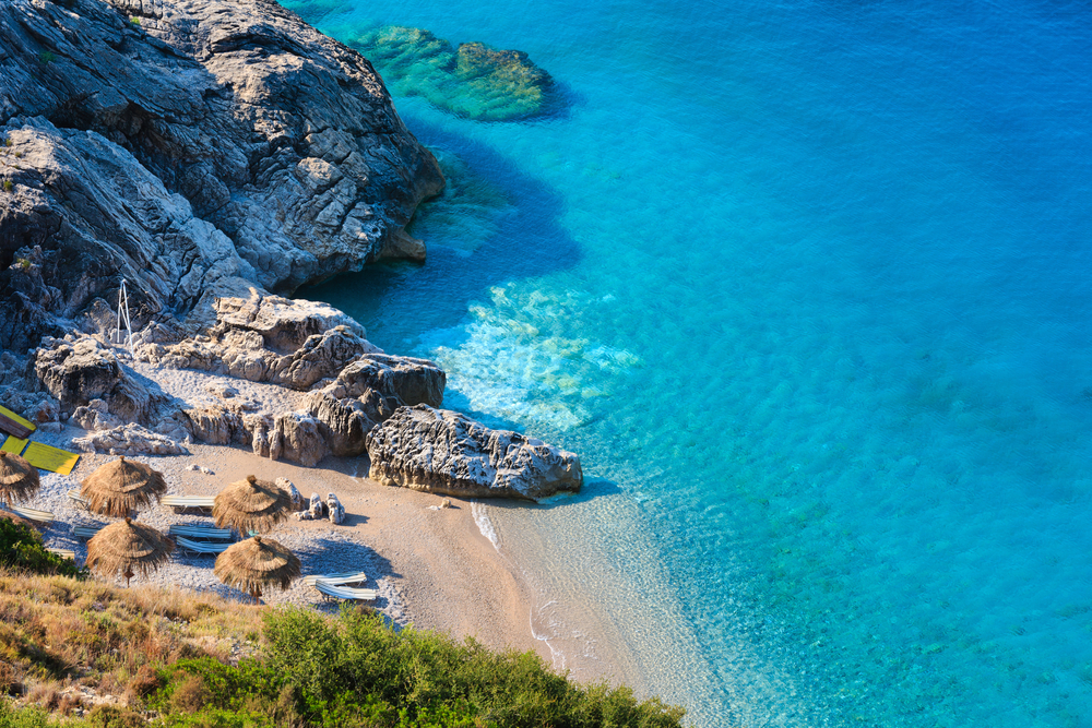 blue+waters+and+a+small+beach+cove+in+albania.jpeg