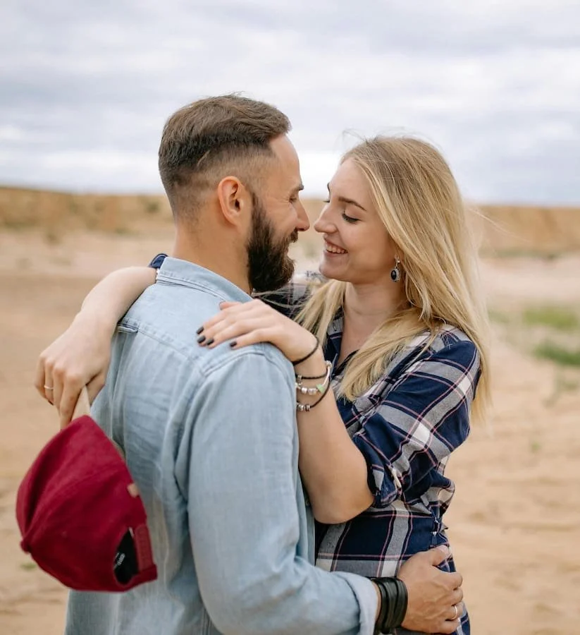 A couple hugging each other and smiling