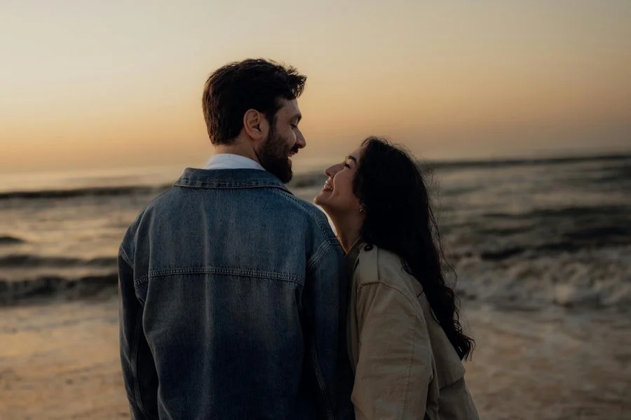 a couple smiling at the beach
