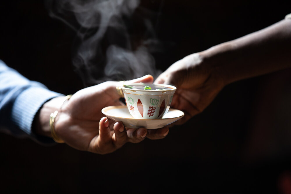  Coffee originated from Ethiopia and it is shared and enjoyed everyday. This photo is morning coffee.&nbsp; The green plant enhances the flavour of the coffee. 