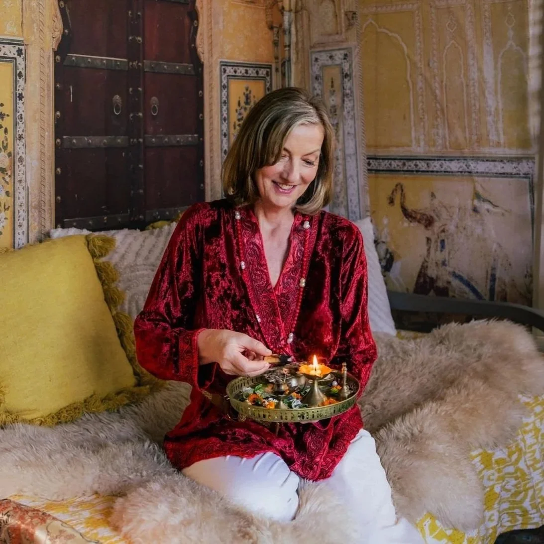 Founder Corinna Maharani demonstrating authentic Ayurvedic Sacred Bodywork techniques while mentoring students during clinical training.