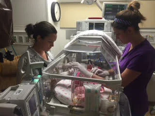 Nurse Anna helps Lora care for her baby.