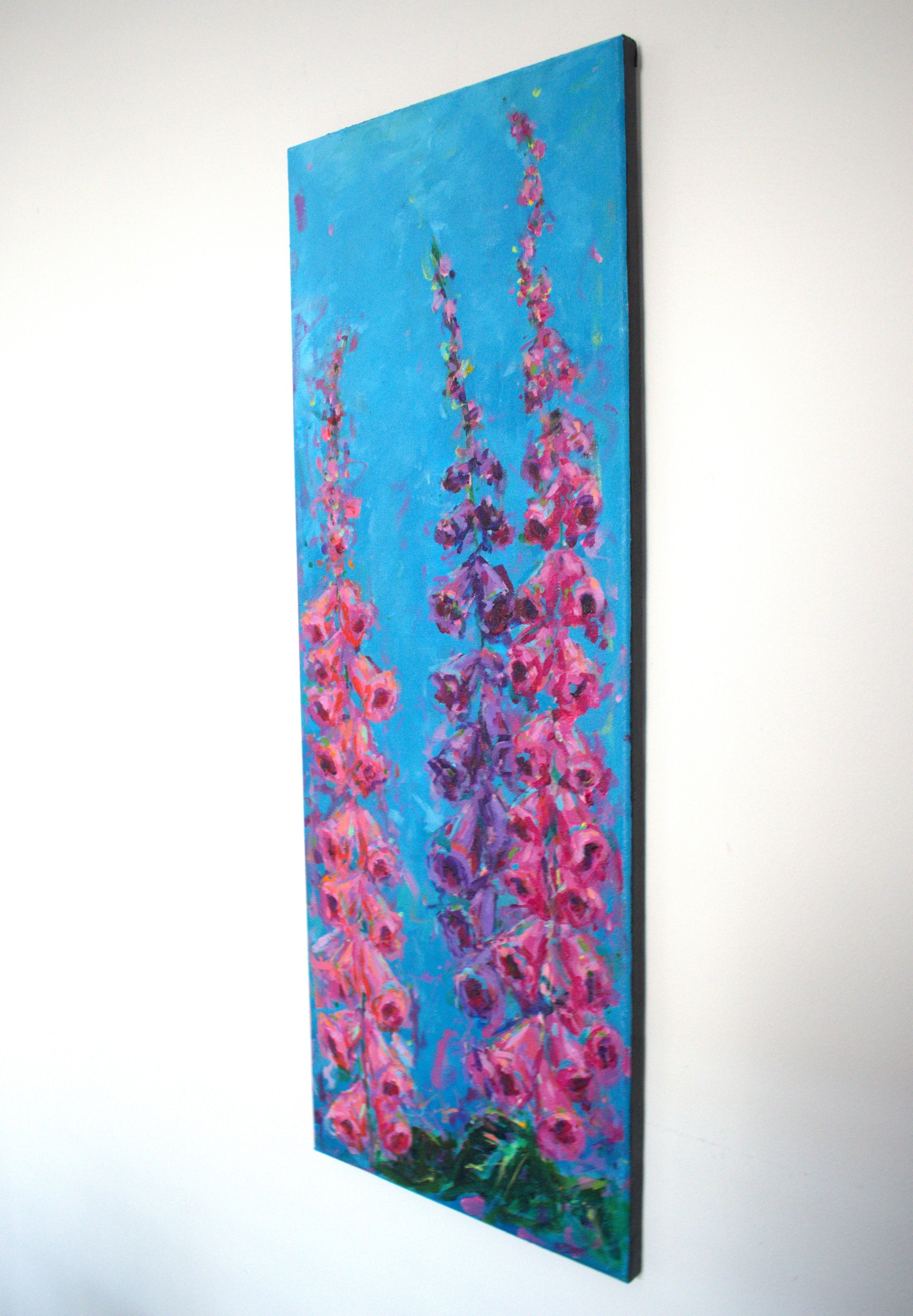 painting of pink and purple foxgloves against a blue background