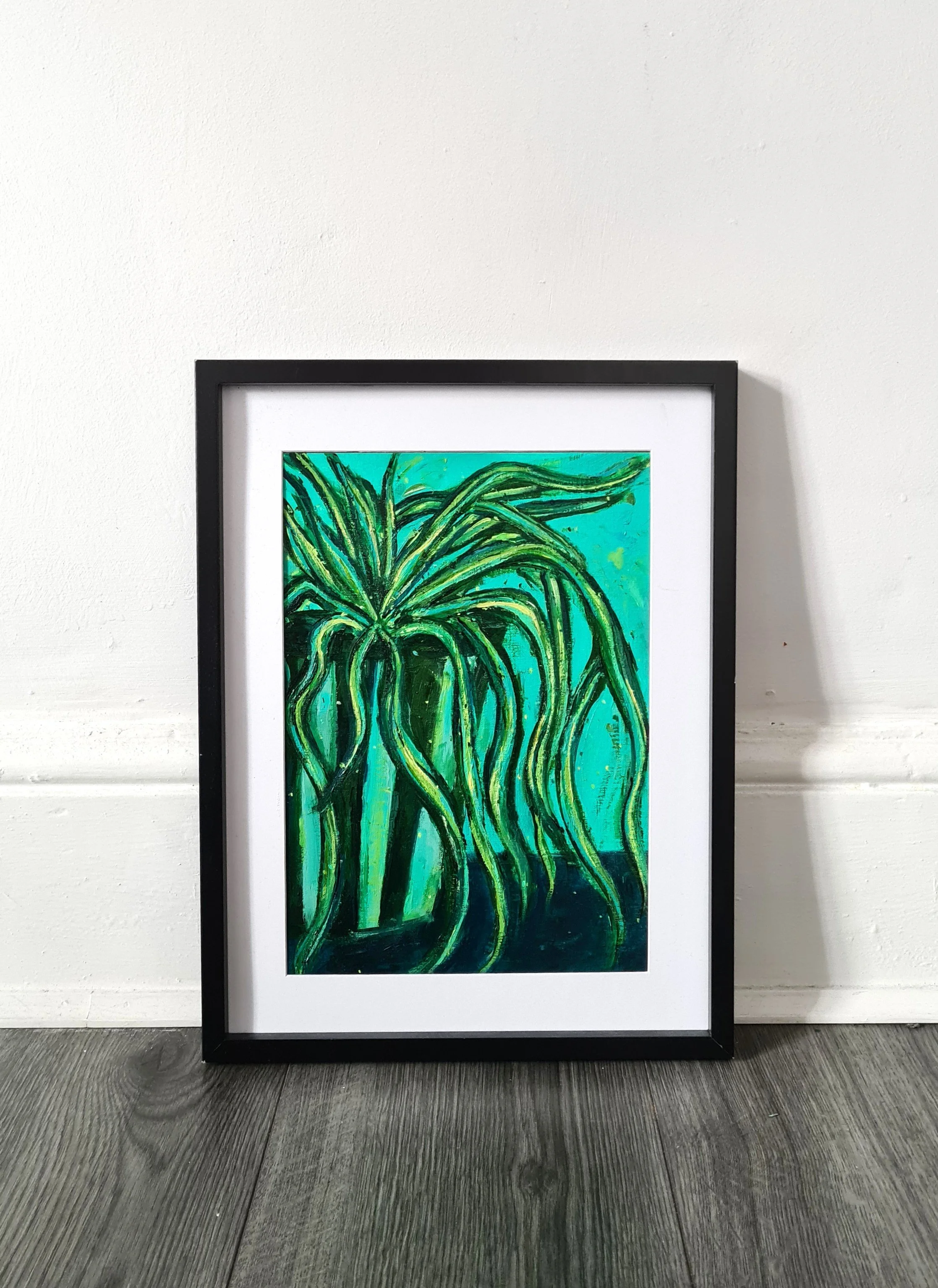 framed green artwork