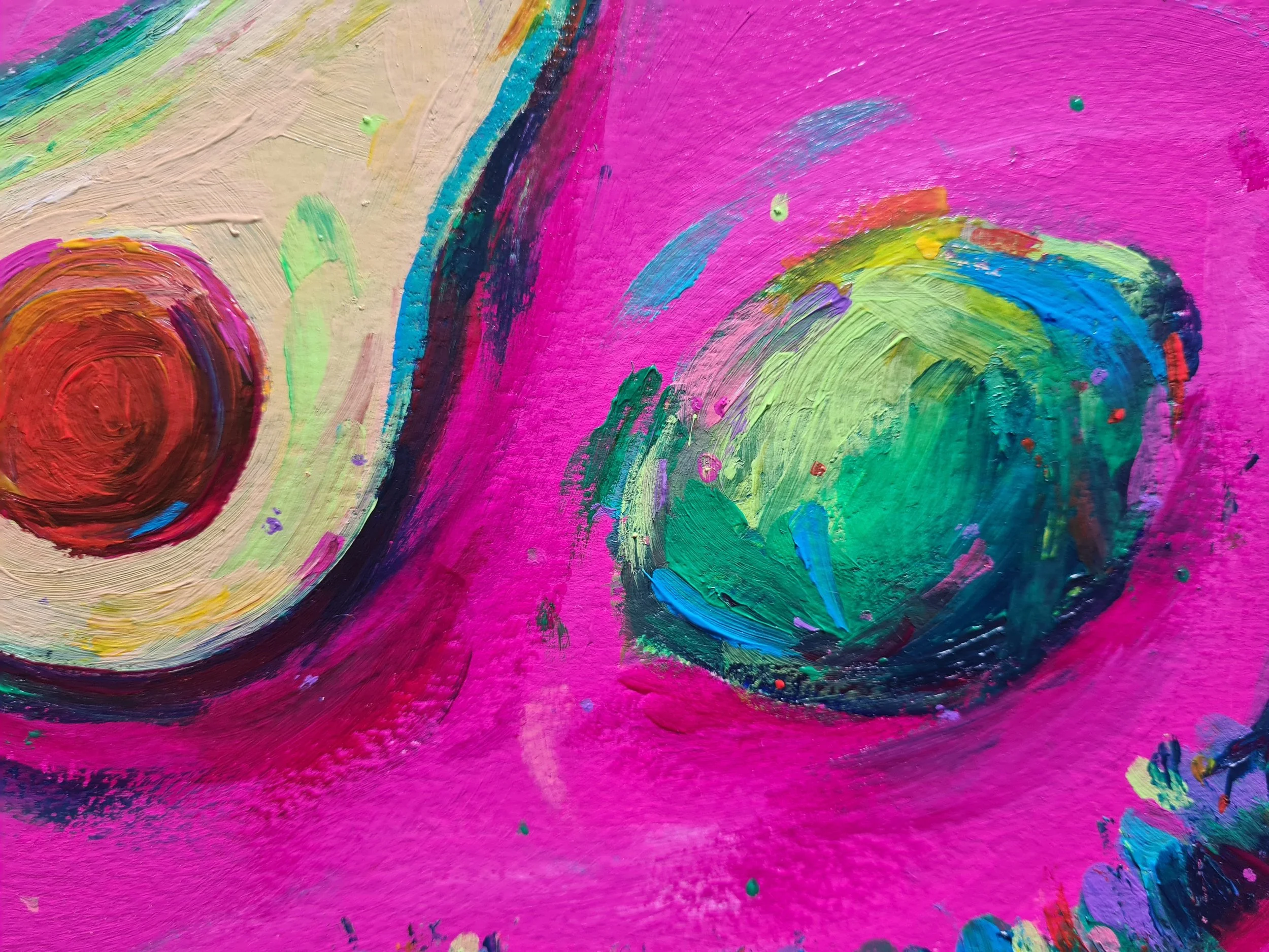 close up of an avocado against a pink background
