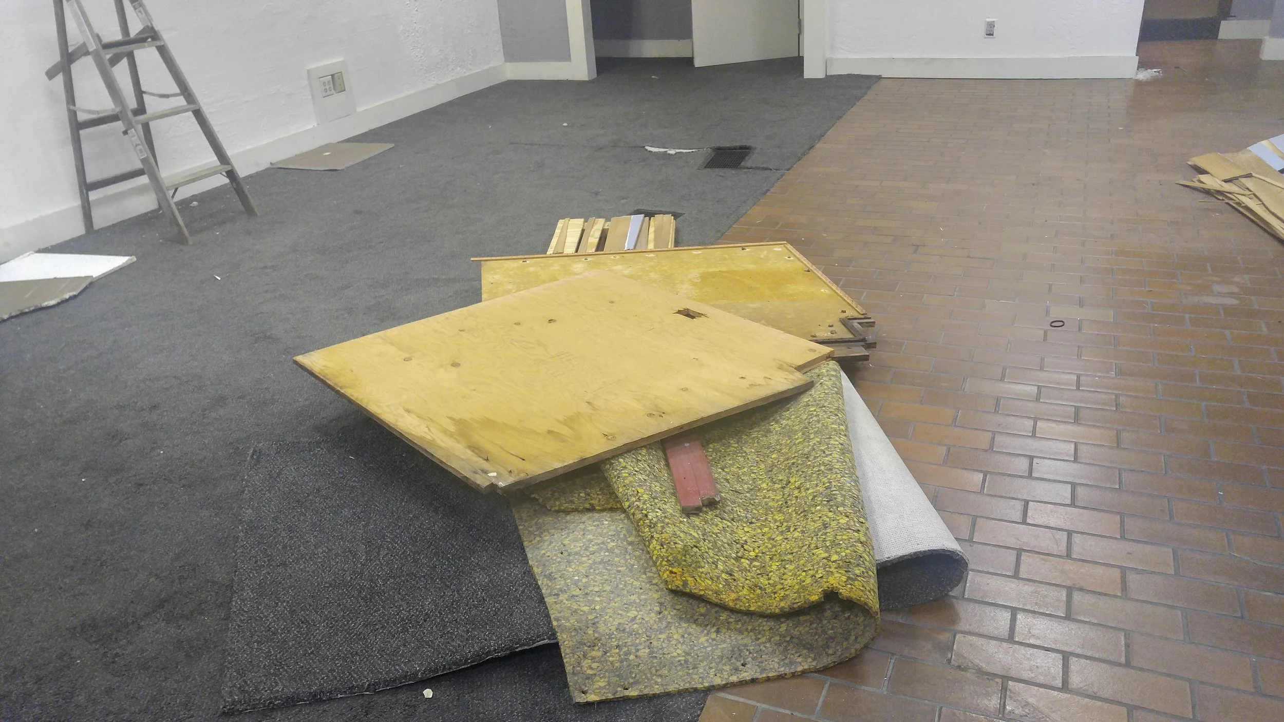 Removal of a window display platform. Seating will be built in its place.