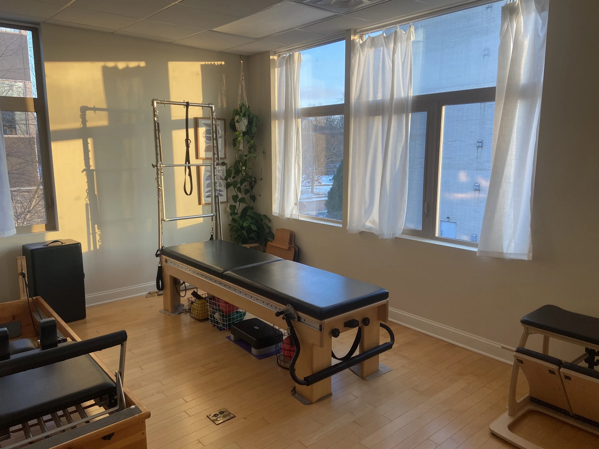 Image of Pilates studio with big windows and flowy curtains.