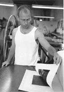 James Groleau pulling a print fresh from the press.