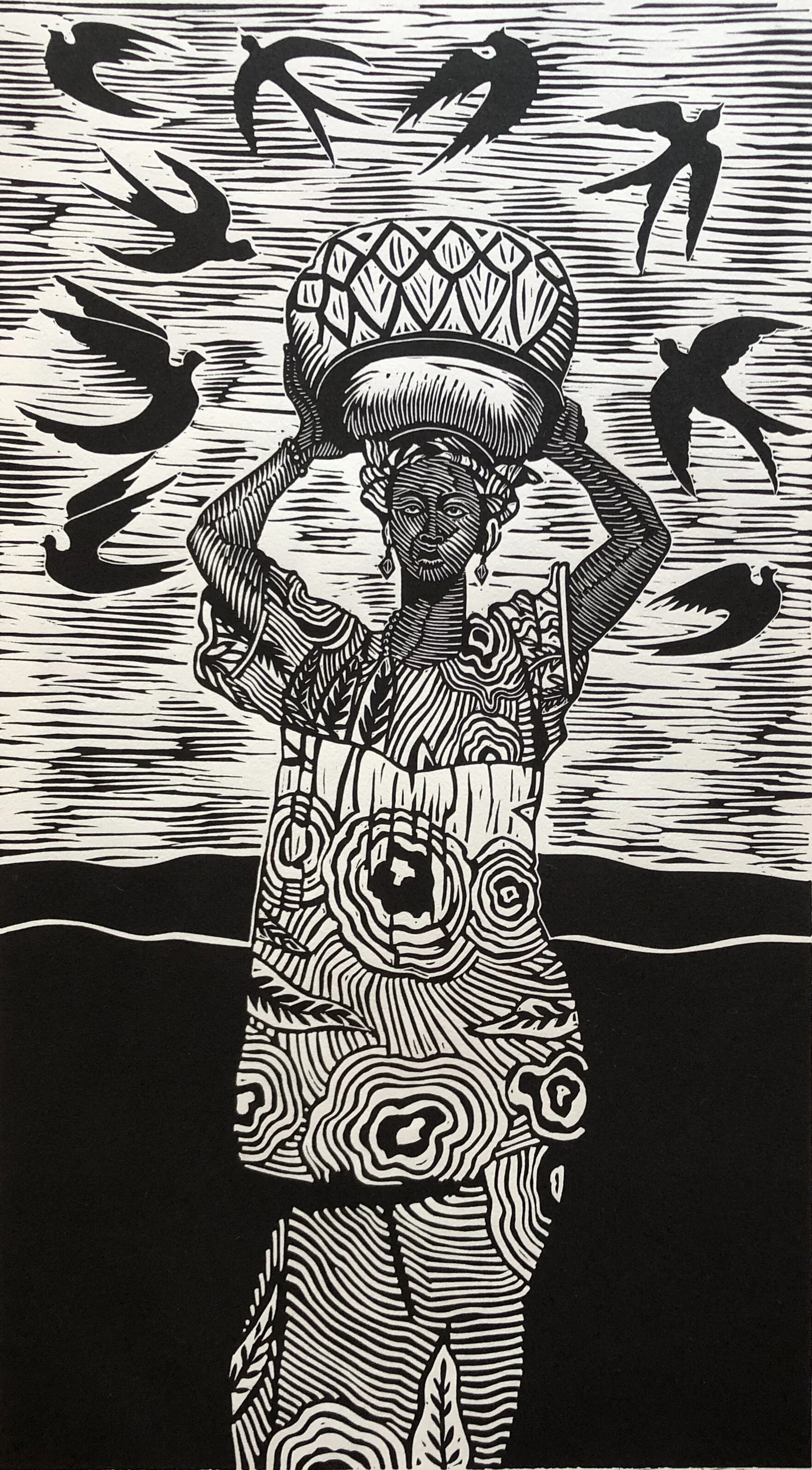 Black-and-white linocut of a woman carrying a vessel on her head with swallows flying overhead; artwork by Juan Fuentes.
