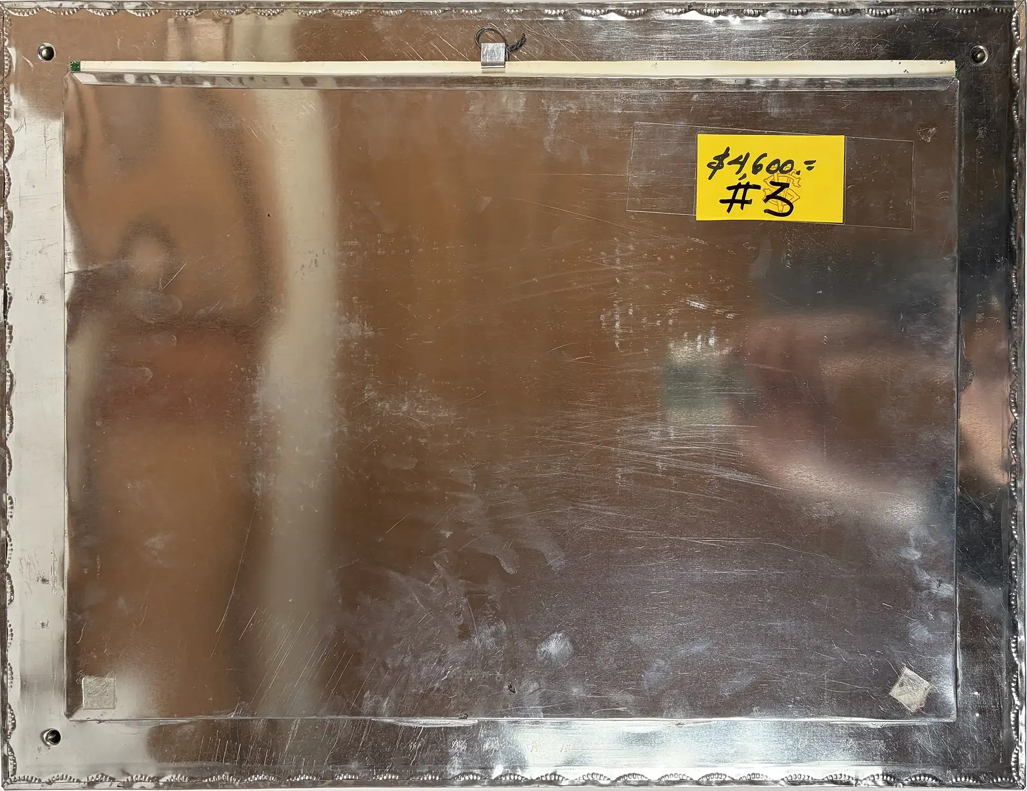 The back of tin frame for Two Faces