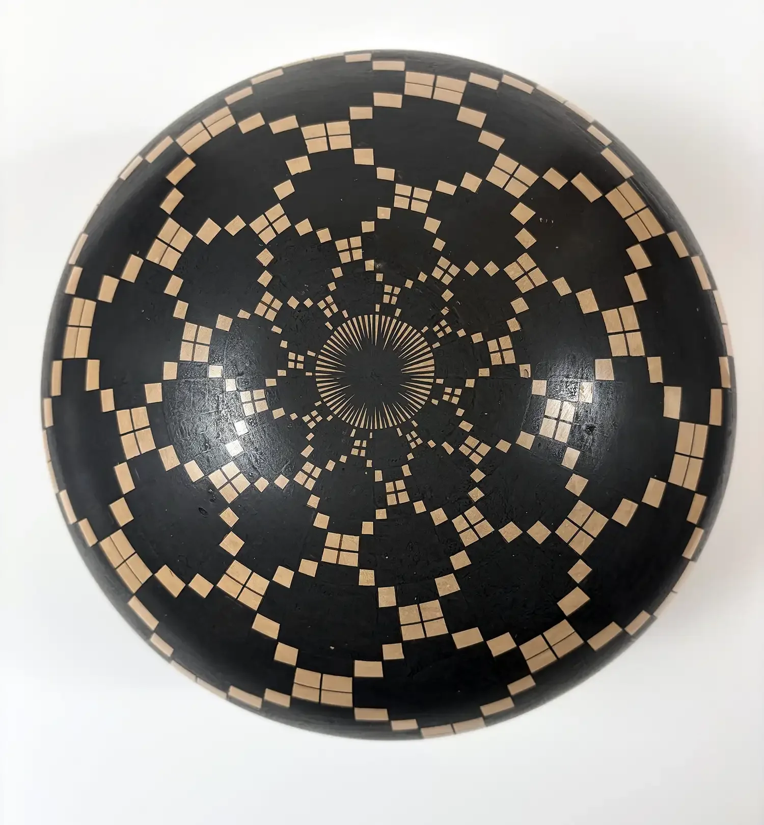 Bottom view of Juan Quezada geometric olla with intricate radiating starburst pattern in black and cream.