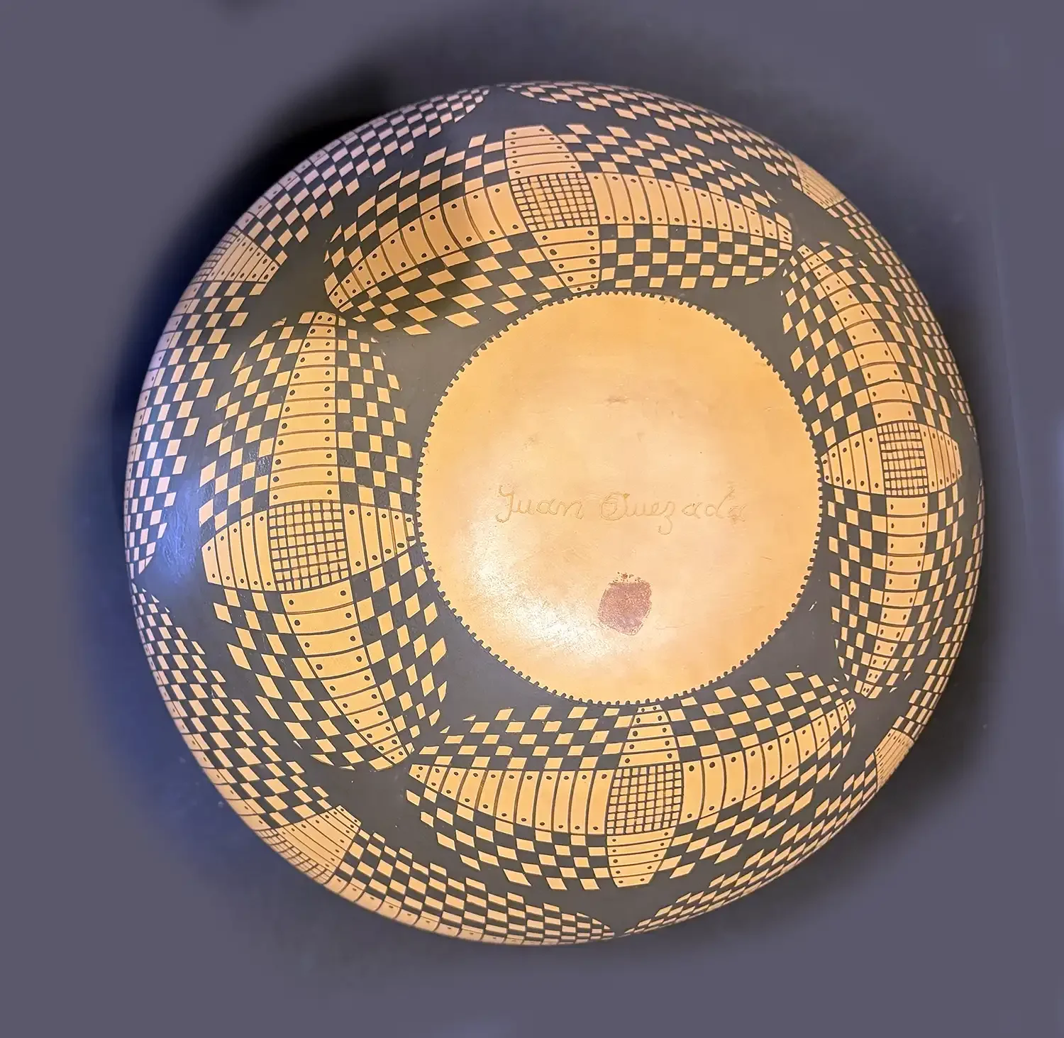 Bottom view of Orange-and-black geometric Mata Ortiz olla, signed by Juan Quezada