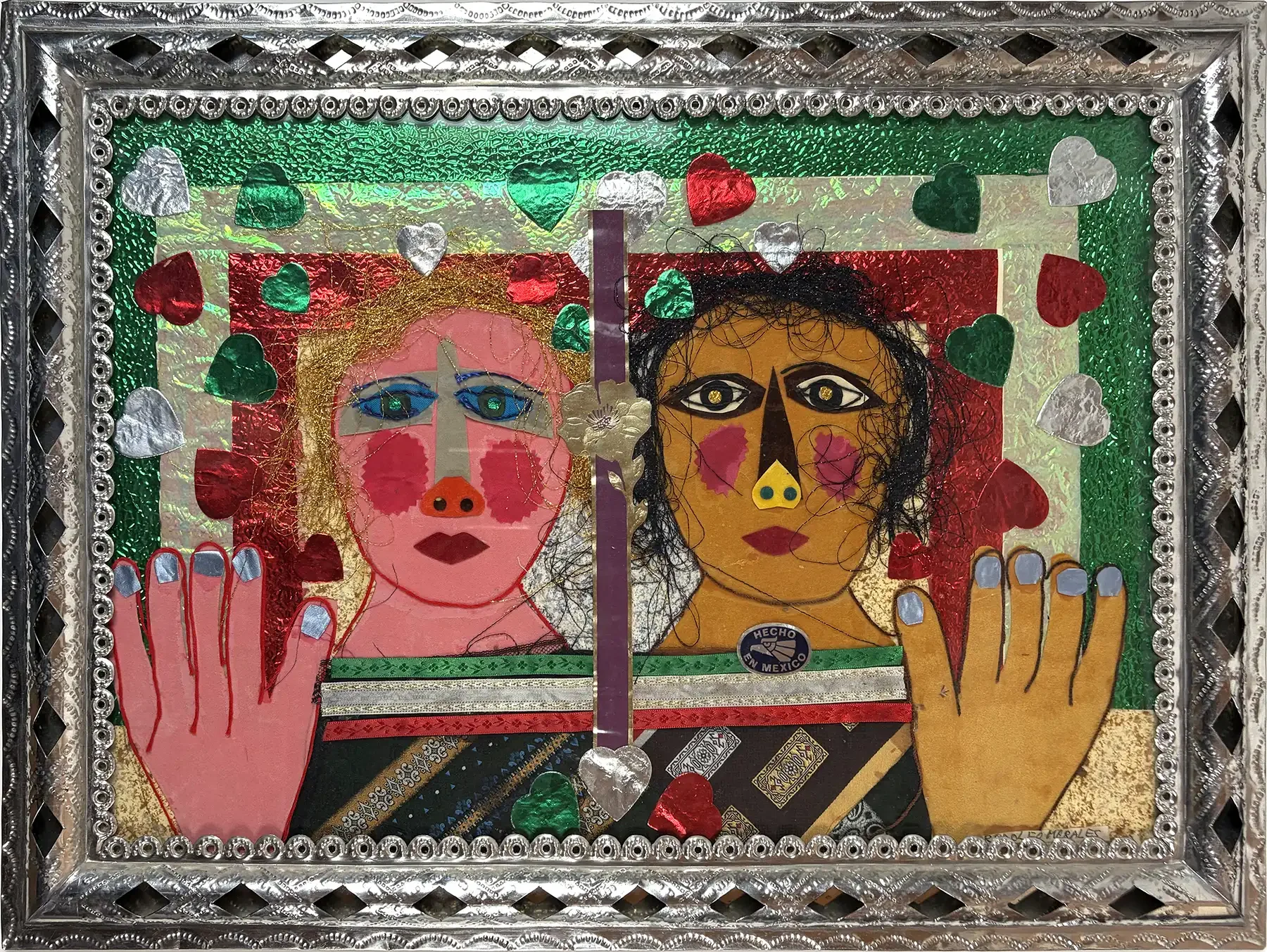 Mixed-media collage by Rodolfo Morales showing two stylized faces with foil hearts, fabric elements, and original hand-tooled tin frame.
