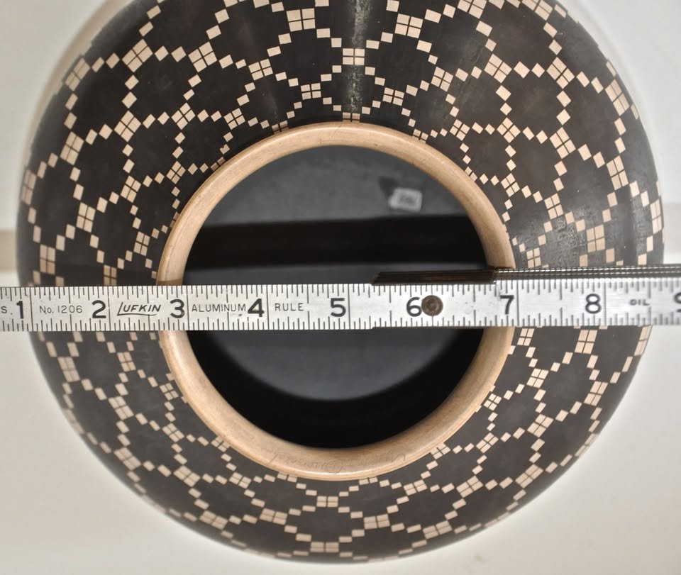 op view of Juan Quezada black-on-white geometric Mata Ortiz olla with ruler showing opening width.