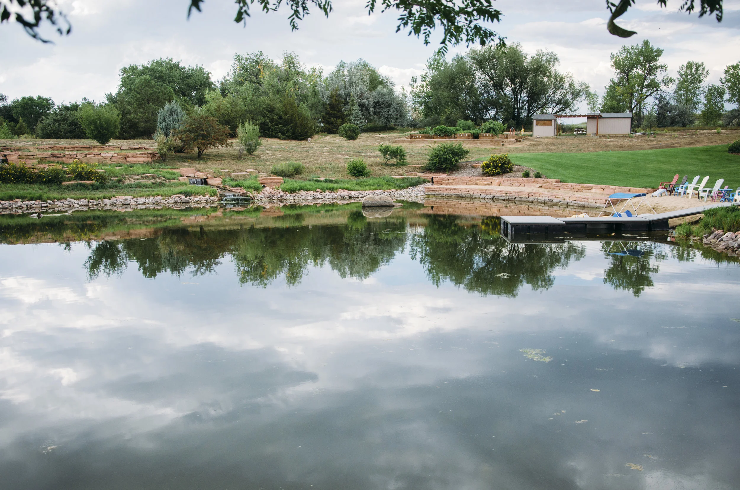  After a few failed attempts by other companies to create a pond, this client asked us to create a peaceful oasis in their backyard with the foothills of Boulder as a backdrop. A unique mix of formal stacked strip stone and uncut sandstone boulders w