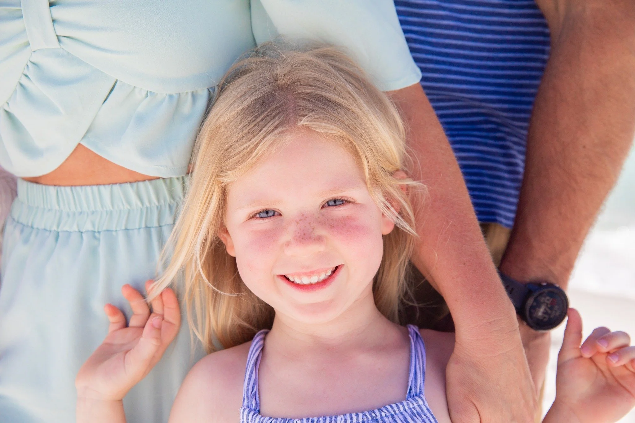 Those little freckles. 
Even though our sessions can be wonderfully chaotic with excited children running around the beach, I always make it a priority to capture the little details that make them uniquely them.
The freckles across their nose, the ga